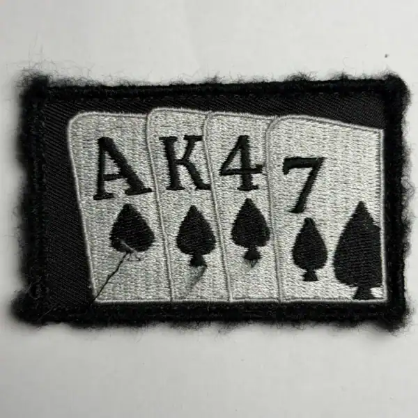 AK47 Russian trophy patch with playing card symbols embroidered on black textile background