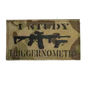 Russian trophy gear patch with firearm silhouettes and English combat slogan on camouflage fabric
