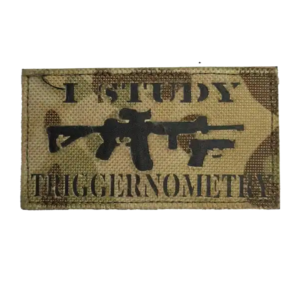 Russian trophy gear patch with firearm silhouettes and English combat slogan on camouflage fabric