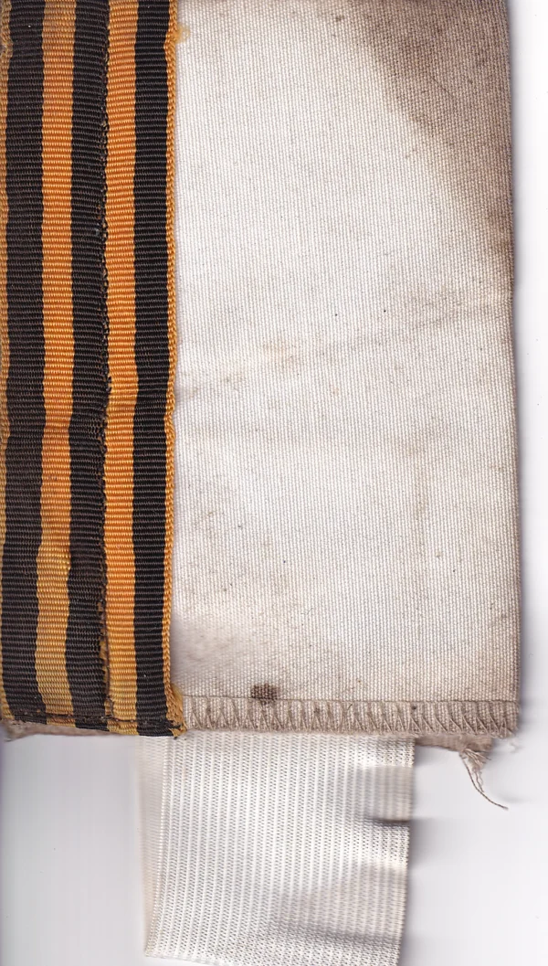 Russian St George Ribbon Armband with black-and-orange ribbon sewn to a light textile band, visible field wear, staining, and trophy provenance from Ukraine.