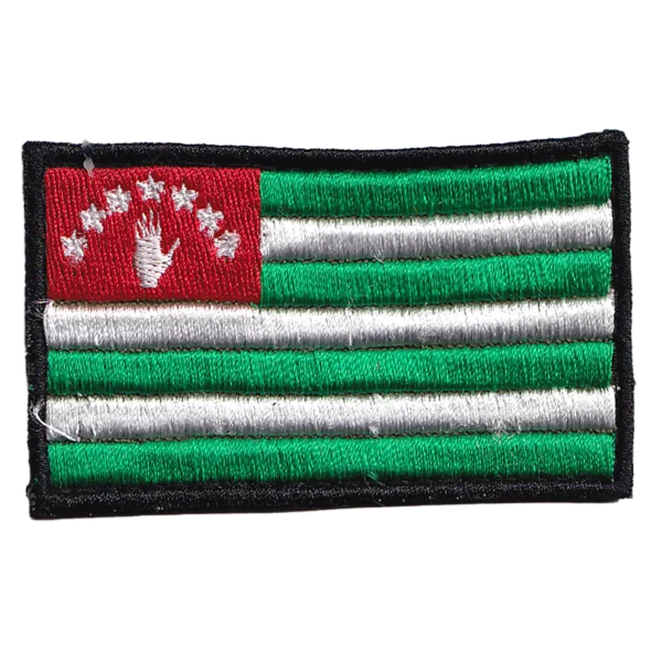 Abkhazia Flag Patch with green and white stripes, red canton, open white hand, seven stars, black embroidered border, and rectangular format.