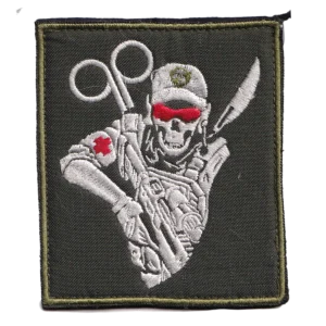 Home 16 Russian combat medic patch with embroidered skeletal field medic, trauma shears, red cross details and olive background, associated with the Russia-Ukraine conflict.