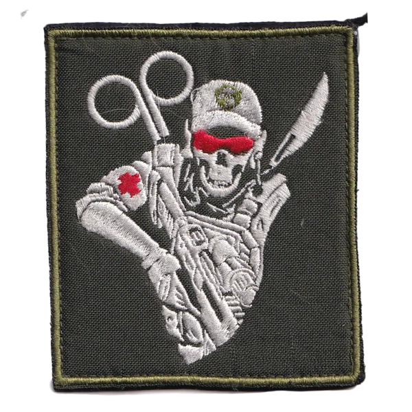 Russian combat medic patch with embroidered skeletal field medic, trauma shears, red cross details and olive background, associated with the Russia-Ukraine conflict.